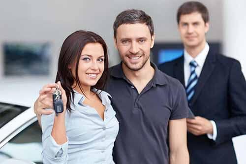 Couple getting car keys for new vehicle at Major World Show room - Major World Reviews Concept image